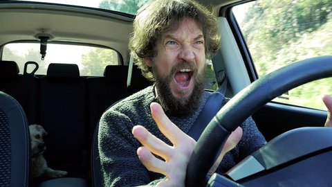 Angry stressed out man screaming in car slow motion