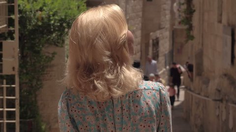 IZRAEL, JERUSALEM - 7 JUNE 2016: Woman tourist walking on the streets of Jerusalem in Israel