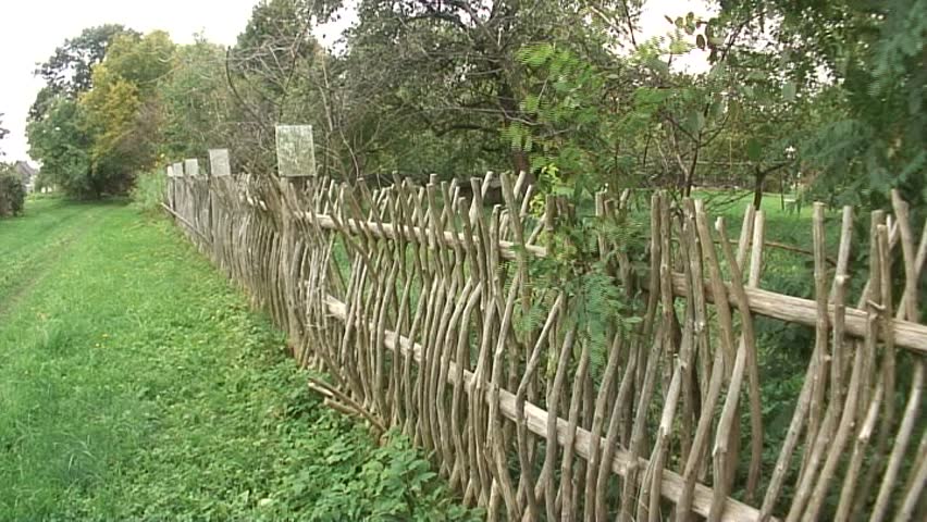 authentic wooden house in the village with wooden fence 