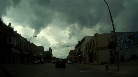 Ontario, Canada August 2106 POV driving under massive supercell thunderstorm with green tinted sky with weather warning in effect
