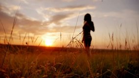 girl puts her hands on sunset in the beautiful landscape slow motion video