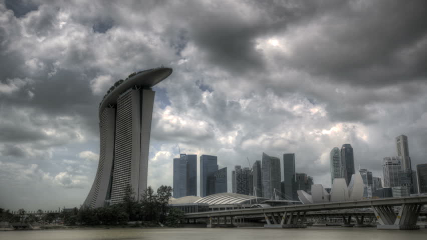 Timelapse Singapore Marina Bay with dark clouds and a view of the harbour bridge