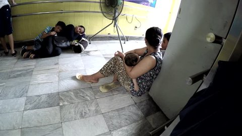 MANILA, PHILIPPINES - AUGUST 18, 2016: Many patients seeking medical attention queue patiently waiting at government hospital lobby