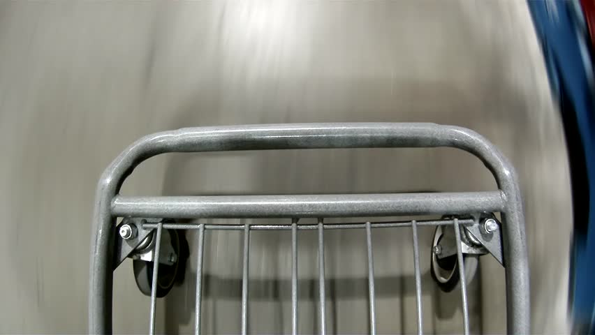 Walking with the shopping cart in a store.