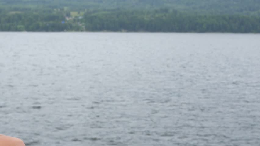 child on boat looks into the distance