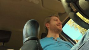 Happy driver shifting the manual stick. Putting car into the first gear. 4K video, low angle view