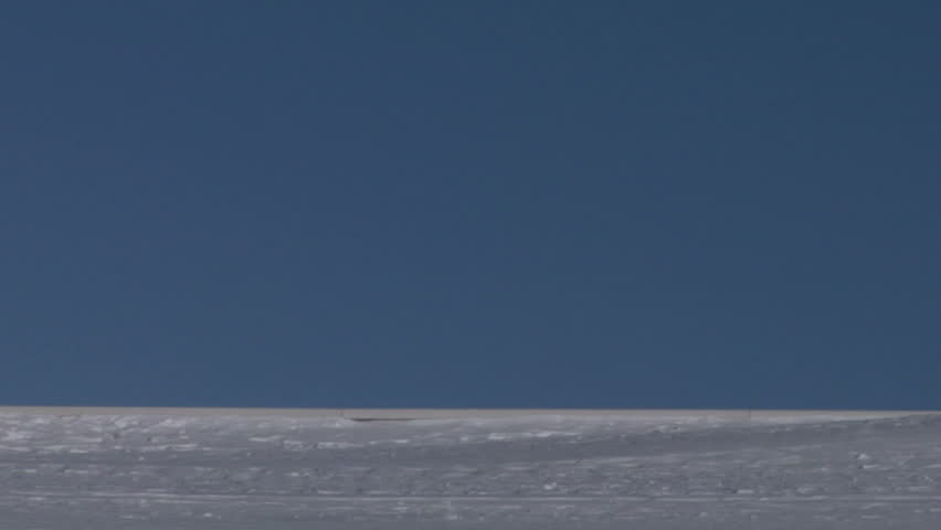 Skier walking over a snowed mountain ridge