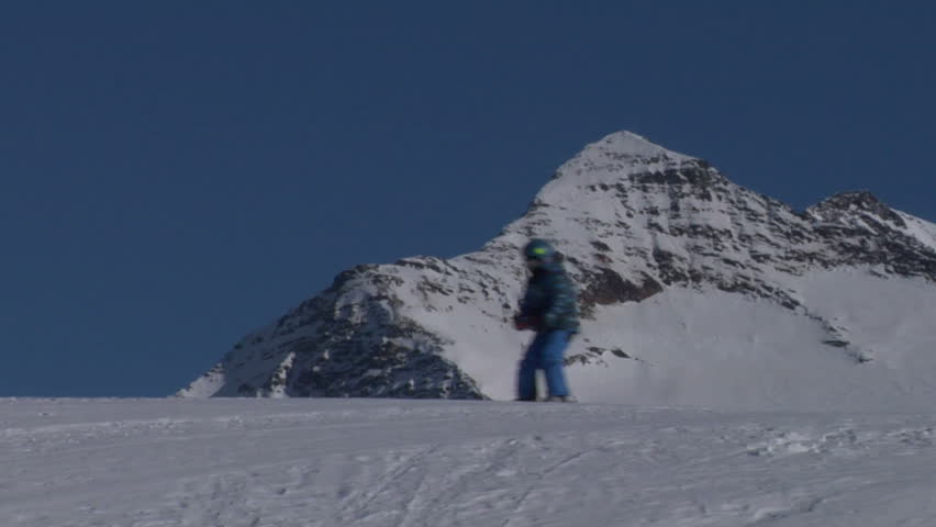 Skier walking over a snowed mountain ridge
