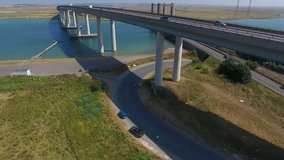 4K footage of a dramatic highway bridge over a blue water river