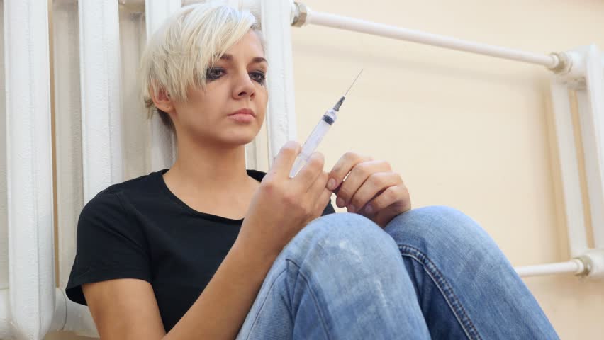 Face of Young Girl Holding Syringe