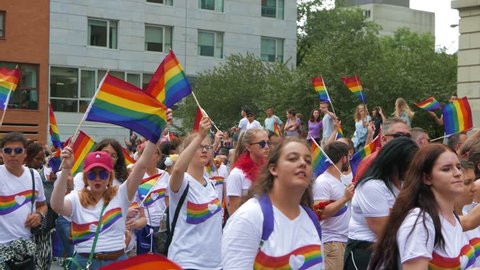 MONTREAL, CANADA - August 2016 : Young people waving the rainbow flag during the parade. Filmed During the 2016 annual LGBT gay pride parade festival in Montreal, Canada.のエディトリアル動画素材
