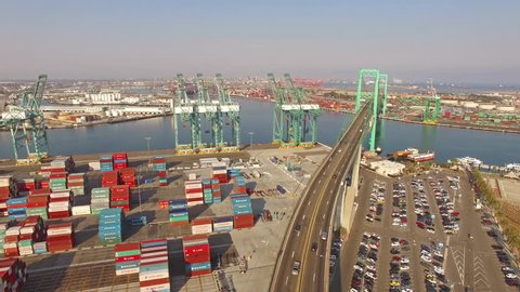 4K Aerial Hyperlapse view moving backward from shipyard and freeway. Long Beach, Los Angeles, CA, USA