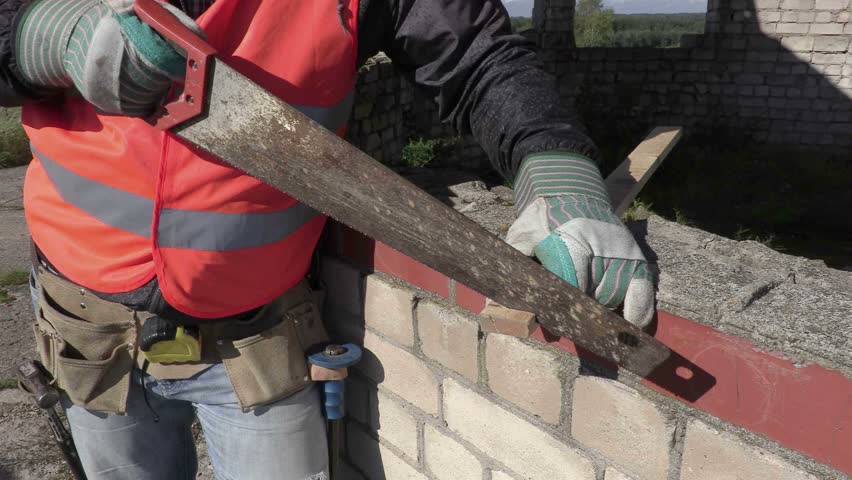 Construction worker using handsaw