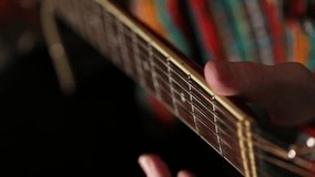 Mexican poncho and sombrero playing guitar, hands guitarist guitar fingers on the fretboard, guitar, string, close-up, video, HD