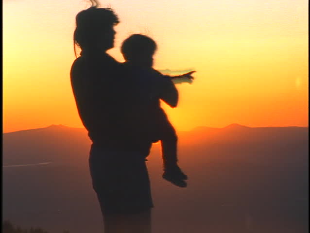 A woman holds a child and they observe a landscape. | Shutterstock HD Video #1894138