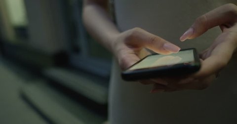 Texting woman on a smartphone device shot on RED Cinema Camera