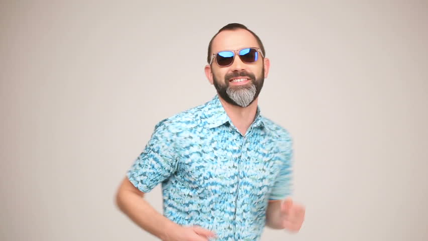Adult bearded man in sunglasses posing