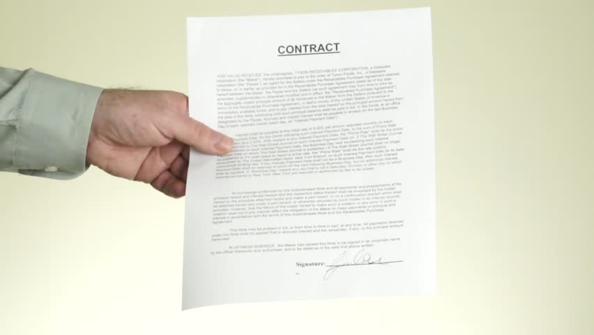 People concluding a contract by shaking hands.