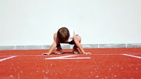Funny video with a 2 years old boy preparing to run in an athletic track