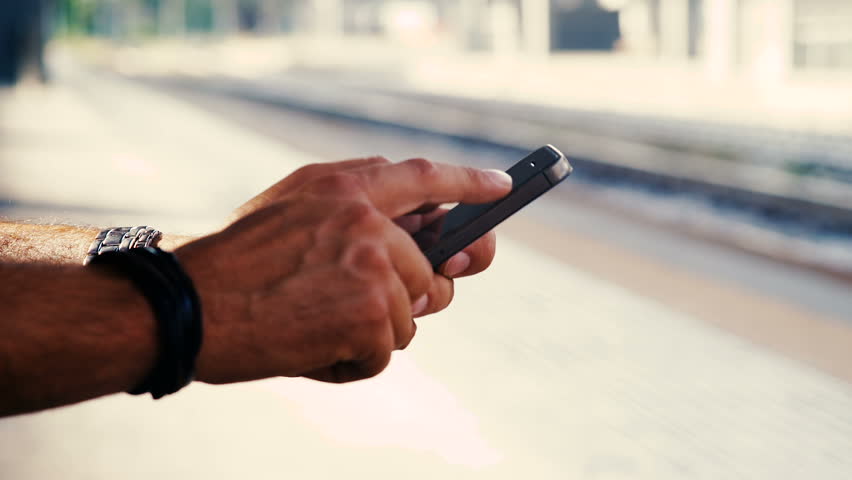 Typing on a smartphone at the station