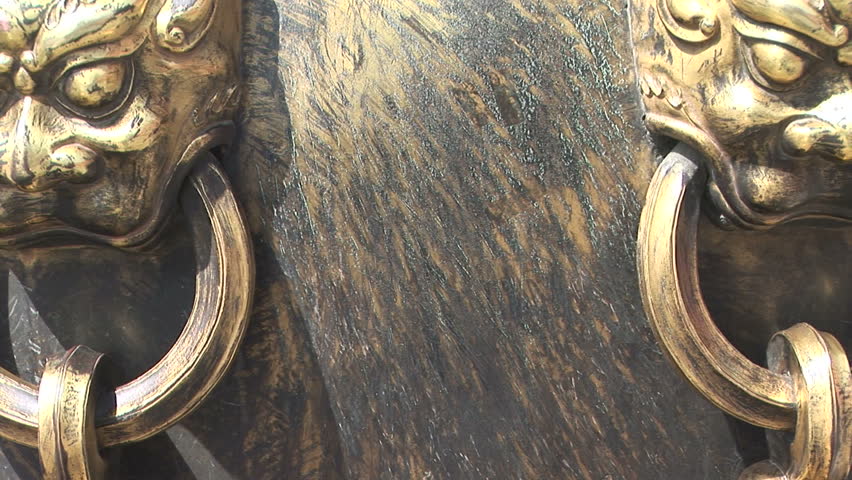 Zoom out shot of Lion Head handles on an ancient Chinese Fire Bowl containing water in case of fire, Forbidden City, Beijing, China