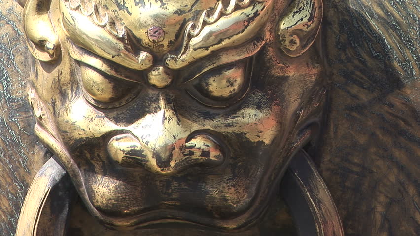 Zoom out shot of Lion Head handle on an ancient Chinese Fire Bowl containing water in case of fire, Forbidden City, Beijing, China