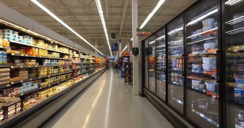 MONTREAL, CANADA - AUGUST 2016: Shopping Inside Walmart - Professional Steadicam Shot (Refrigerated Dairy Products, Eggs, Cheese, Butter, Yogurt & Ice Cream)