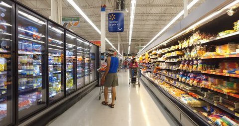 MONTREAL, CANADA - AUGUST 2016: Shopping Inside Walmart - Professional Steadicam Shot (Refrigerated Dairy Products, Eggs, Cheese, Butter, Yogurt & Ice Cream)