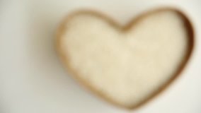 DOF Rice with heart shaped in basket on white background.