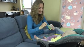 Playful nanny put potato mash in infant child mouth at home. 4K UHD video clip.