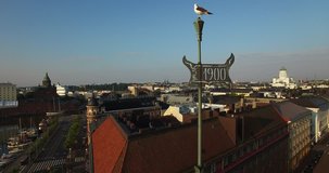 Drone close-up video of Baltic Seagull, vane on old building and Helsinki old town skyline