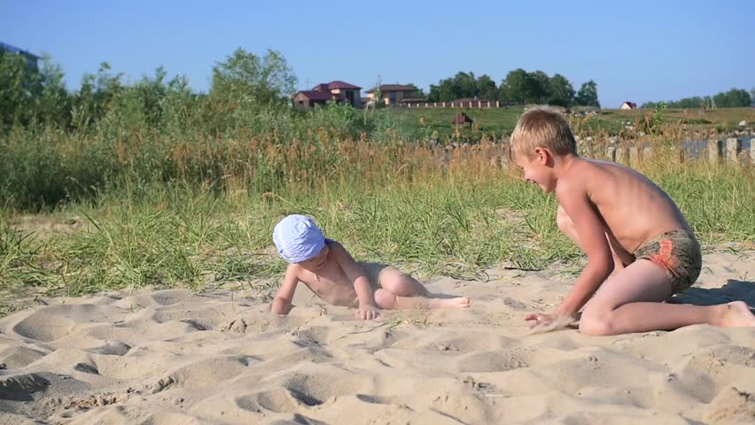 children playing on the beach with sand