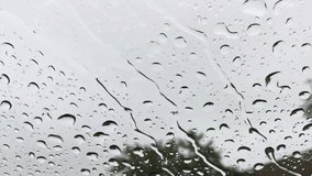 Close up of water drops running on car windshield