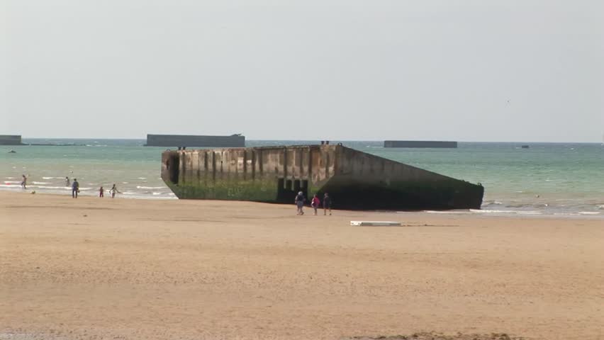 Zoom in to remnants of WWII Mulberry artificial Habour on Gold Beach Arromanches-les-Bains where the Normandy landings took place on D-Day June 6th 1944 in Calvados Department Normandy, France