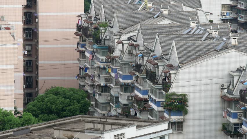 Wuhan China low rise apartments high density living long shot high angle day with balconies, laundry, hanging plants, cables, roof tops, air conditioning units 