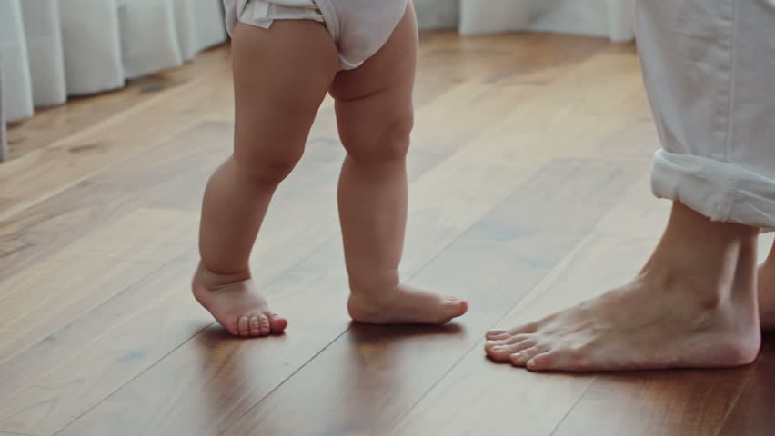 baby walking on side of foot