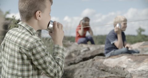 Kids are talking to each other with tin can phone