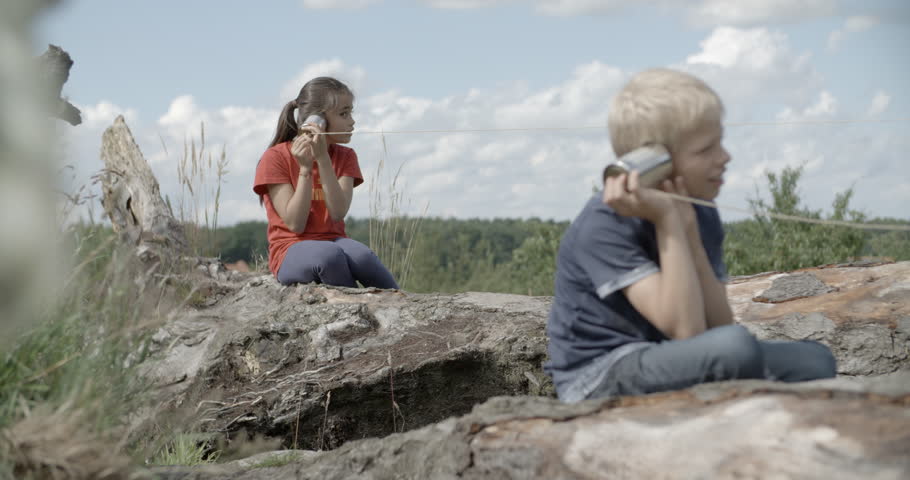 Kids are talking to each other with tin can phone