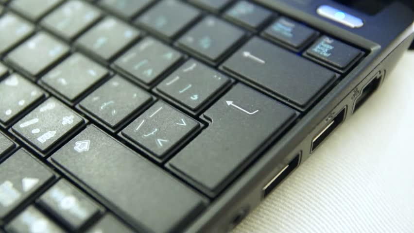 Finger typing the Enter key on a laptop keyboard.