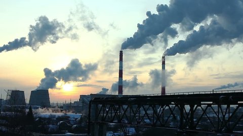 Industrial winter view at sunset with smoke