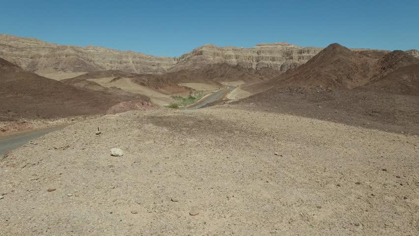 Car crosses the desert. Aerial shot.Desert view from the top