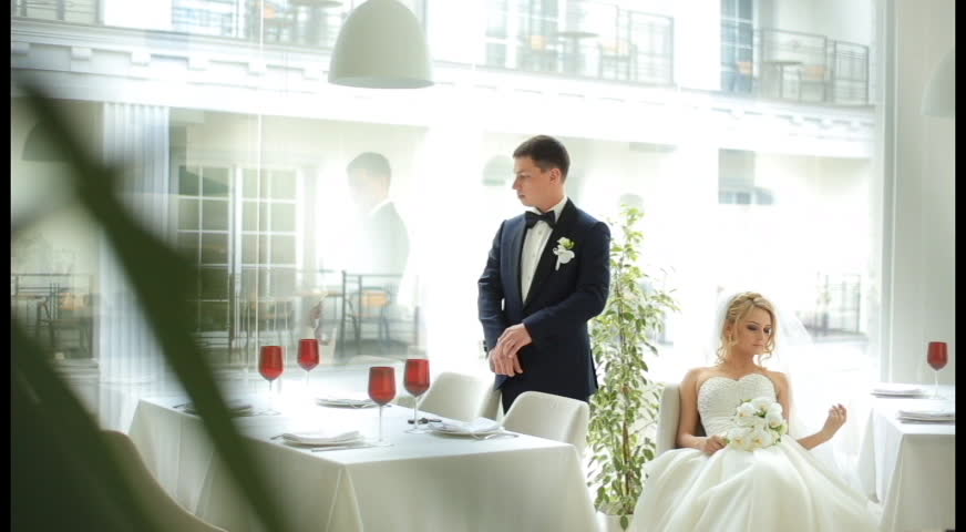 Attractive bride and groom on their wedding celebration in the luxury panoramic restaurant