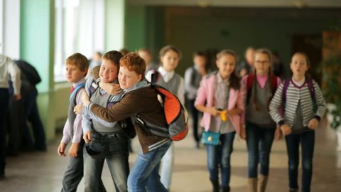 Russia, Novosibirsk, 2015: Children go by the school hallway during recess. School change. Two schoolmates. School weekdays. School in Russia