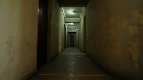 4K Old apartment building,long dark hallway pov track-in,walking.Tracking in on the corridor of an old apartment building,long and dark hallway.