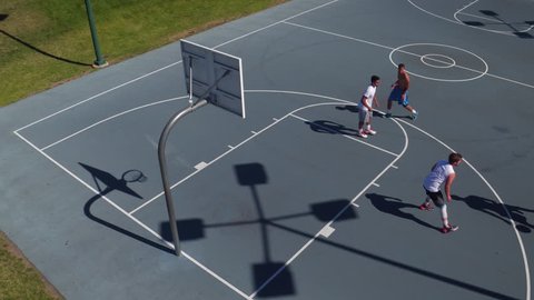 Friends playing basketball at park, high angle shot Video de stock