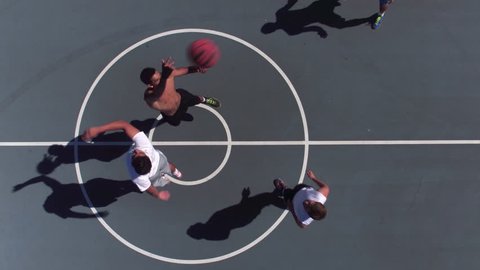 Friends playing basketball at park, overhead shot of tip off
