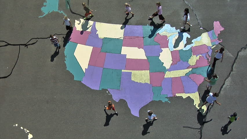 HD overhead shot of twelve kids circling around the United States painted on the