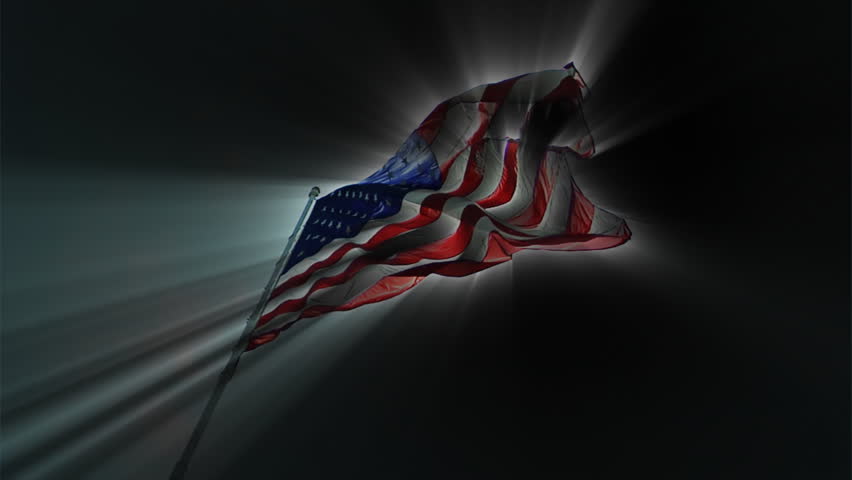 Cool HD clip of the American flag wavering with bright rays around it with a