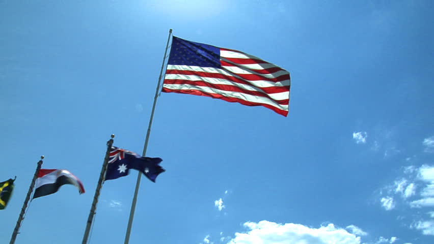 HD clip of nine different flags wavering in the wind with the American flag