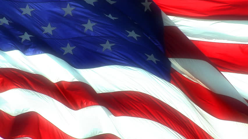 A bright HD clip of the American flag wavering close up.